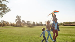 Family enjoying time at the park and getting budget-ready this summer